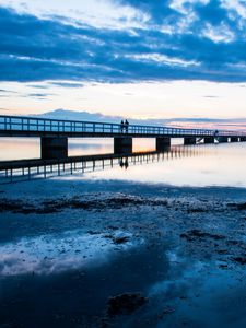 Preview wallpaper shore, bridge, silhouettes, sea, water, twilight