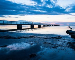 Preview wallpaper shore, bridge, silhouettes, sea, water, twilight