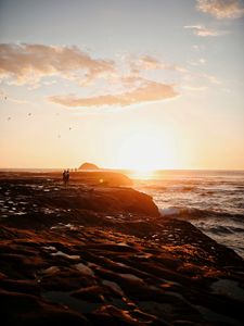 Preview wallpaper shore, sea, sunset, silhouettes, clouds, surf