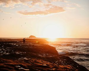 Preview wallpaper shore, sea, sunset, silhouettes, clouds, surf