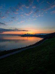 Preview wallpaper shore, water, horizon, buildings, sunset, dark