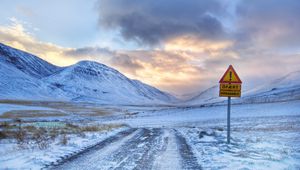 Preview wallpaper sign, prevention, mountains, road, snow, protectors, sky, clouds