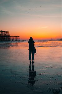 Preview wallpaper silhouette, alone, beach, sea, sunset, dark