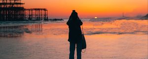 Preview wallpaper silhouette, alone, beach, sea, sunset, dark