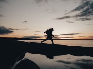 Preview wallpaper silhouette, alone, coast, sea, twilight, dark