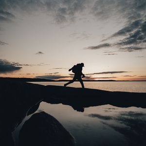 Preview wallpaper silhouette, alone, coast, sea, twilight, dark