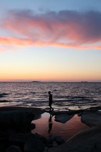 Preview wallpaper silhouette, alone, coast, sea, dark, twilight