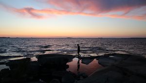 Preview wallpaper silhouette, alone, coast, sea, dark, twilight