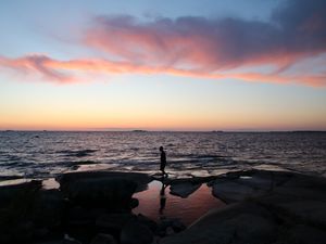 Preview wallpaper silhouette, alone, coast, sea, dark, twilight