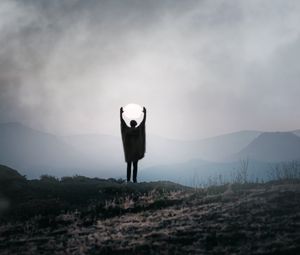 Preview wallpaper silhouette, alone, gesture, moon, mountains