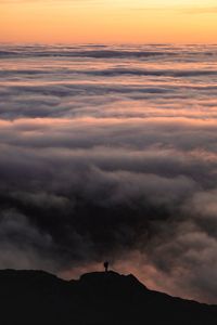 Preview wallpaper silhouette, alone, mountain, peak, clouds