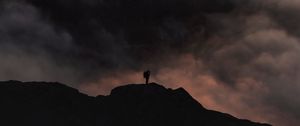 Preview wallpaper silhouette, alone, mountain, peak, clouds