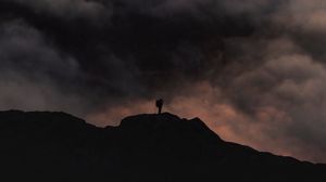 Preview wallpaper silhouette, alone, mountain, peak, clouds