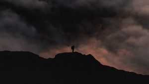Preview wallpaper silhouette, alone, mountain, peak, clouds