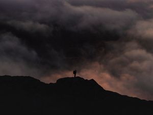 Preview wallpaper silhouette, alone, mountain, peak, clouds