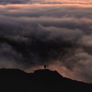 Preview wallpaper silhouette, alone, mountain, peak, clouds