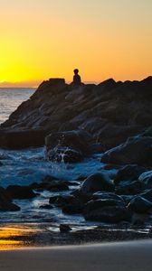 Preview wallpaper silhouette, alone, rocks, sea, horizon, sunset