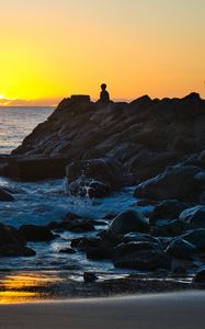 Preview wallpaper silhouette, alone, rocks, sea, horizon, sunset