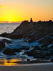 Preview wallpaper silhouette, alone, rocks, sea, horizon, sunset