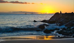 Preview wallpaper silhouette, alone, rocks, sea, horizon, sunset