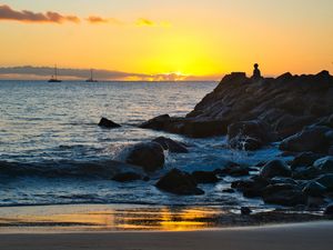 Preview wallpaper silhouette, alone, rocks, sea, horizon, sunset