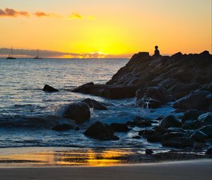 Preview wallpaper silhouette, alone, rocks, sea, horizon, sunset