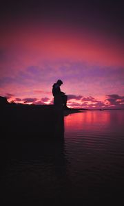 Preview wallpaper silhouette, alone, sad, sea, clouds, sunset, dark