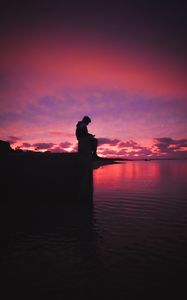 Preview wallpaper silhouette, alone, sad, sea, clouds, sunset, dark