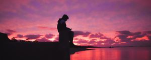 Preview wallpaper silhouette, alone, sad, sea, clouds, sunset, dark