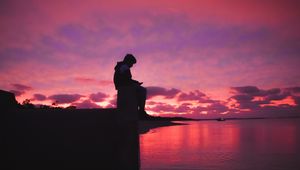 Preview wallpaper silhouette, alone, sad, sea, clouds, sunset, dark