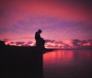 Preview wallpaper silhouette, alone, sad, sea, clouds, sunset, dark