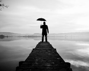 Preview wallpaper silhouette, alone, umbrella, hat, pier, water, black and white