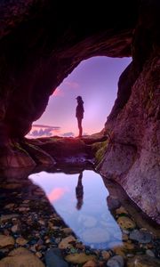 Preview wallpaper silhouette, cave, water, stones, reflection