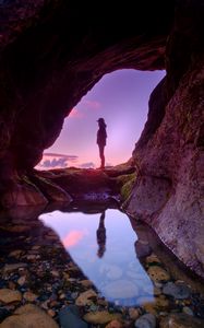 Preview wallpaper silhouette, cave, water, stones, reflection