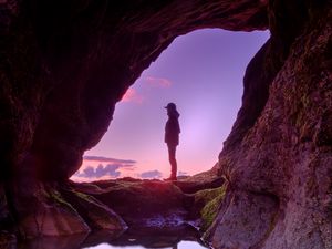 Preview wallpaper silhouette, cave, water, stones, reflection