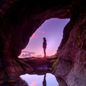 Preview wallpaper silhouette, cave, water, stones, reflection