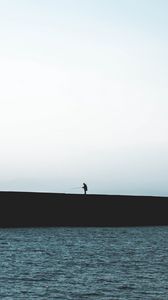 Preview wallpaper silhouette, coast, dark, sea, fisherman