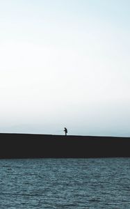 Preview wallpaper silhouette, coast, dark, sea, fisherman