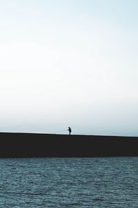 Preview wallpaper silhouette, coast, dark, sea, fisherman