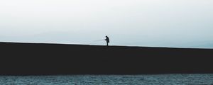 Preview wallpaper silhouette, coast, dark, sea, fisherman