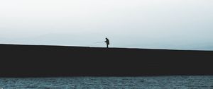 Preview wallpaper silhouette, coast, dark, sea, fisherman