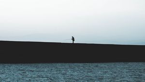 Preview wallpaper silhouette, coast, dark, sea, fisherman