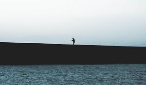 Preview wallpaper silhouette, coast, dark, sea, fisherman