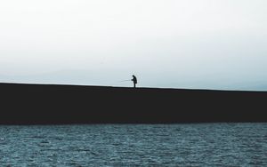 Preview wallpaper silhouette, coast, dark, sea, fisherman