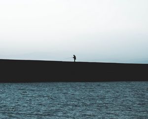 Preview wallpaper silhouette, coast, dark, sea, fisherman