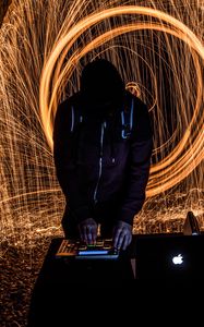 Preview wallpaper silhouette, dj, light, sparks, long exposure, dark