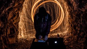 Preview wallpaper silhouette, dj, light, sparks, long exposure, dark