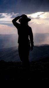 Preview wallpaper silhouette, hat, mountains, dark