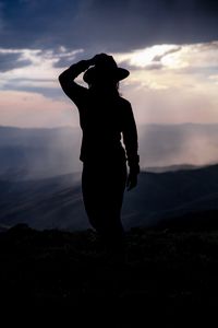Preview wallpaper silhouette, hat, mountains, dark