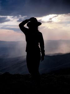Preview wallpaper silhouette, hat, mountains, dark